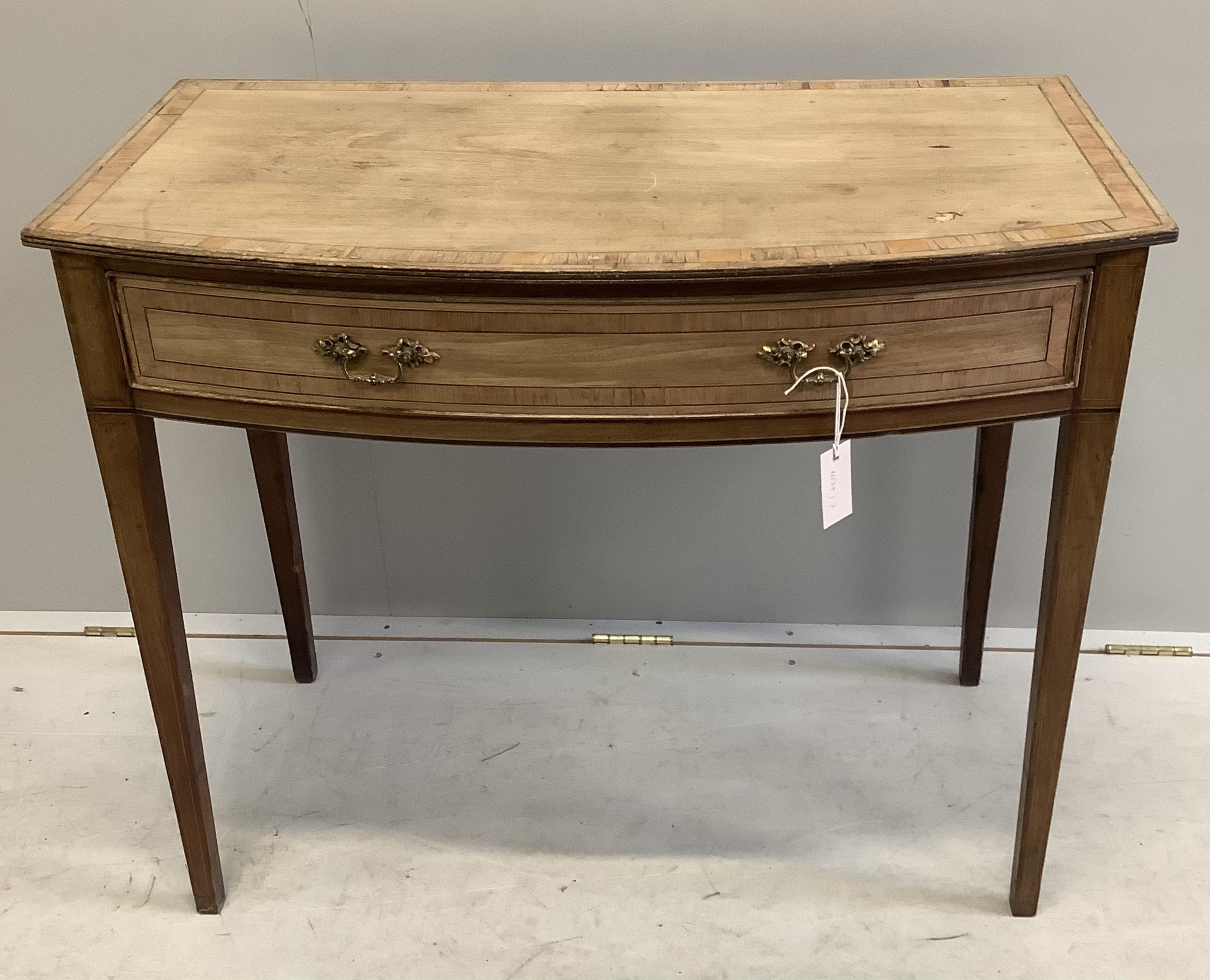 A George III faded banded mahogany bowfront side table, width 91cm, depth 49cm, height 76cm. Condition - poor to fair